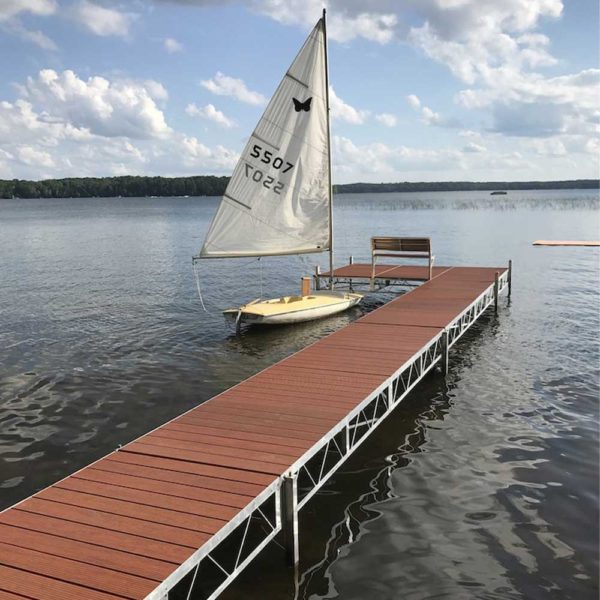 Sail boat by rolling jack dock on lake