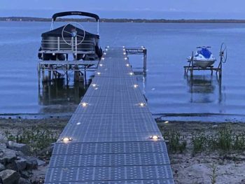 lights on a dock with a boat lift