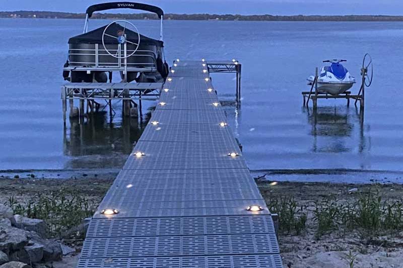 lights on a dock with a boat lift