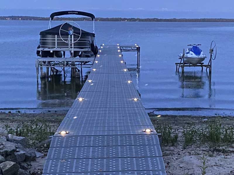 lights on a dock with a boat lift