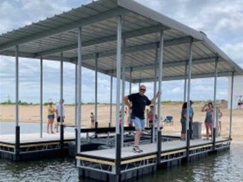 Man Standing on a floating dock with a canopy over it
